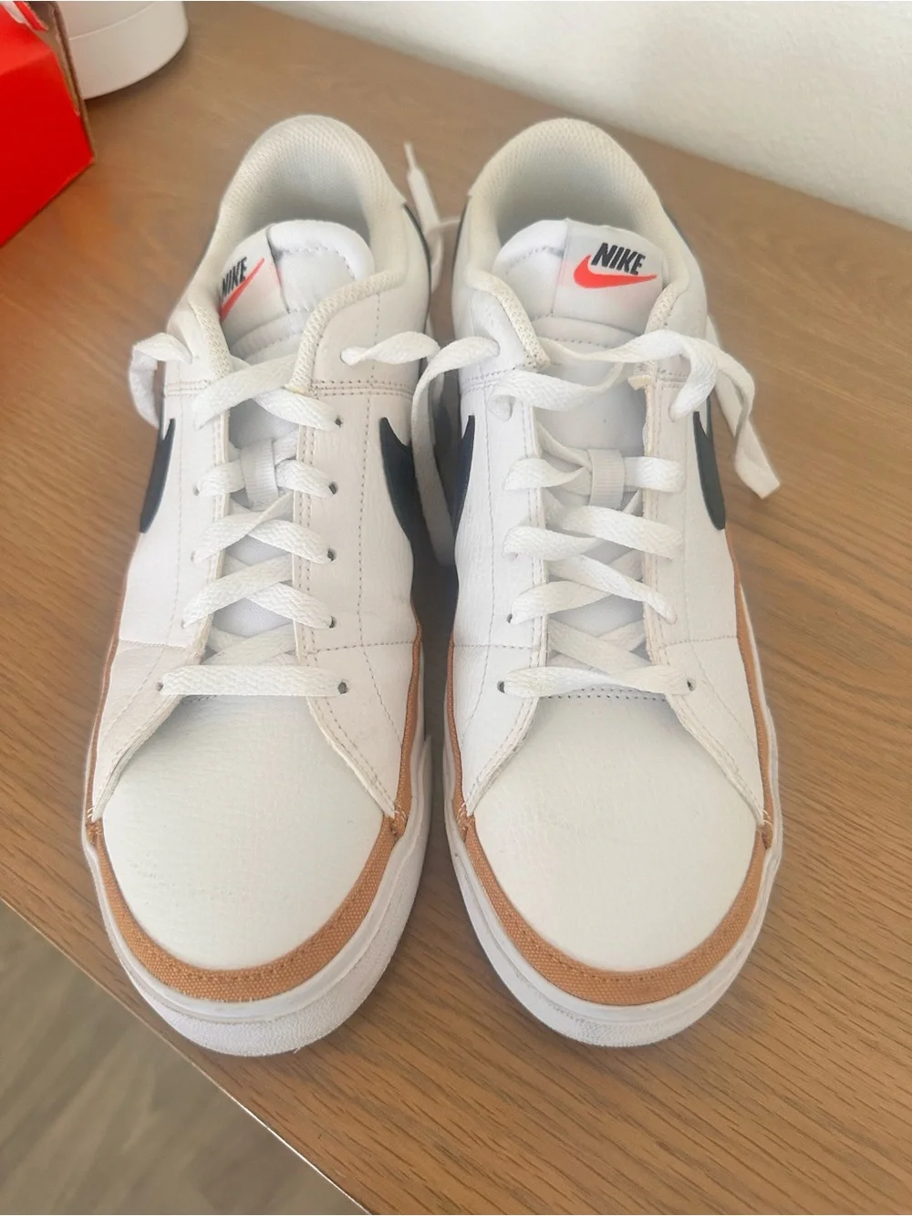 Nike White Low-Top Sneakers with Black Swoosh and Brown Trim